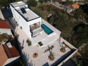 an overhead view of a house with a swimming pool at Domo Oliveto in Vinišće