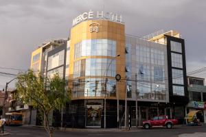a large building with a hotel sign on it at Mercé Hotel in Tacna