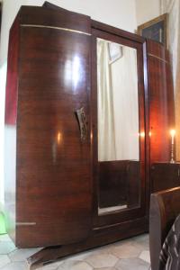 a wooden cabinet with a glass door in a room at Maison du 18ème Siècle in Tunis