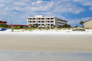 a hotel on the beach next to the water at Guy Harvey Resort on Saint Augustine Beach in Saint Augustine Beach
