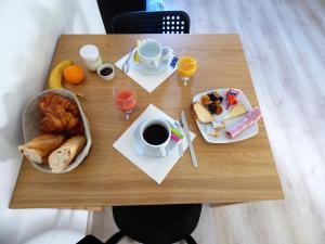 a table with breakfast foods and coffee on it at Les Hauts de Malirat in Capdenac-Gare