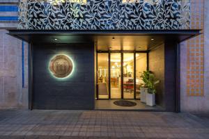 a store front of a building with a sign on it at The Convo Porto Hotel & Apartment in Porto