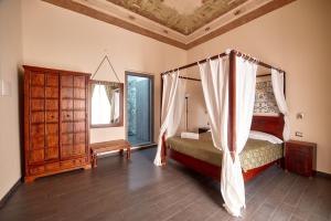 a bedroom with a canopy bed and a mirror at La Terrazza sul Centro in Palermo