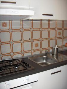 a kitchen with a sink and a stove at Appartamento Giusy in Ventimiglia
