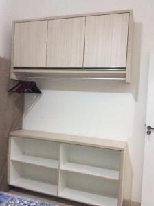 a kitchen with white cabinets and a hood at RESIDENCIAL ANNABEL APTO 03 in Bombinhas