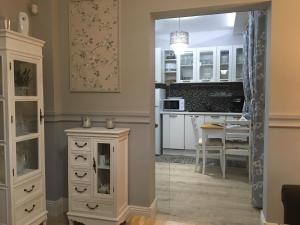 a kitchen with a white cabinet and a table at My Home, with free secure parking in Stara Zagora