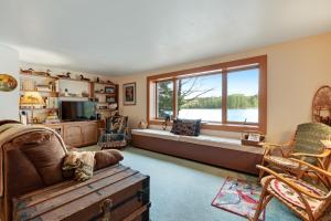 a living room with a couch and a large window at Hotter's Cabin in Sayner