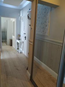 a hallway with a glass door leading into a room at My Home in Stara Zagora