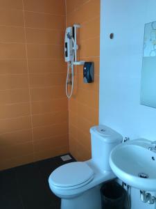 a bathroom with a toilet and a sink at GOODY HOTEL in Johor Bahru