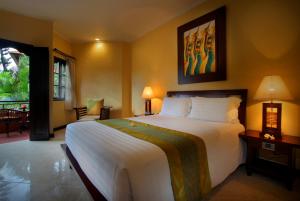 A bed or beds in a room at Adi Dharma Hotel Kuta