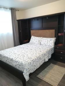 a bedroom with a bed with a white comforter at Montreal Olympic Parc in Montréal