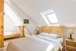 A bed or beds in a room at Agropensiunea Mara