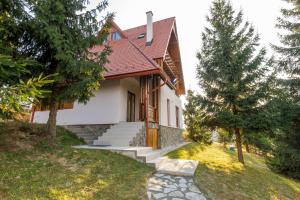 a house with stairs leading up to it at Agropensiunea Mara in Mărişel