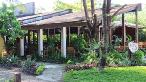 un edificio con porche con bancos y plantas en Pleasant View Resort, en Ngapali