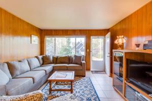 a living room with a couch and a fireplace at 8th Hole Getaway Condo MCA #1209 in Manzanita