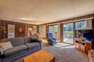 a living room with a couch and a tv at Water's Edge Retreat in Shaver Lake