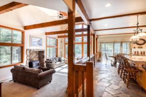 a living room with a fireplace and a dining room at Alderhill in Shaver Lake