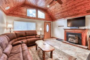 a living room with a couch and a fireplace at The Villager in Shaver Lake