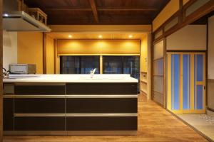 a kitchen with a sink and a window at Musashi Sakaean in Kanazawa