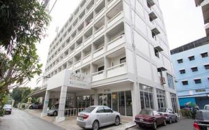 a large white building with cars parked in front of it at Lee Garden Bangkok in Bangkok