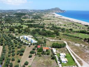 an aerial view of a resort with the beach at TEO-VILLA-1, private pool, sea and golf in Afantou