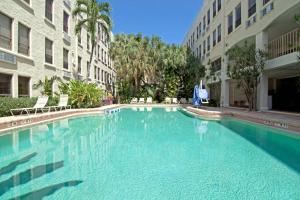 a large swimming pool in front of a building at Hemingway Suites at Palm Beach Hotel Island in Palm Beach
