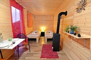 a room with a woodburning stove in a restaurant at Drolma Ling Nature Cabins in Theologos