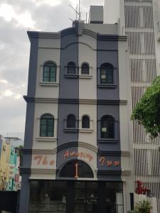 a tall building with a sign on the side of it at The Amazing Inn in Singapore