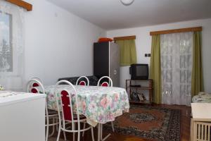 バラトンフェニヴェシュにあるFamilia Nyaraló 87のリビングルーム(テーブル、椅子、テレビ付)