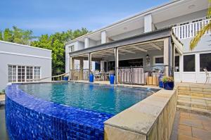 a swimming pool in the backyard of a house at Lodge on Main Guest House and Conference Centre in Port Elizabeth