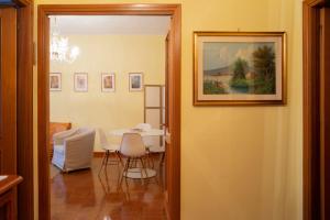 a dining room with a table and a painting on the wall at Da Marzia apartment in LʼAquila +21 photos