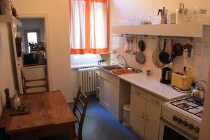 a kitchen with a table and a stove and a sink at Kant in Berlin