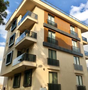 a building with balconies on the side of it at Tuzla Hill Suites in Tuzla