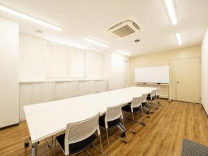 a large conference room with a long table and chairs at Kusatsu Daiichi Hotel in Kusatsu