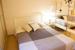 a bedroom with a bed and a shelf at Cozy Studio in Central Glyfada in Athens