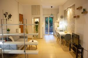 a living room with white shelves and a dining room at Cozy Studio in Central Glyfada in Athens