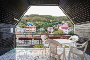 a table and chairs on a balcony with a view at Hotel "Magnoliya" in Tuapse