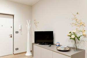 a living room with a tv on a white wall at Casa marina in Genoa