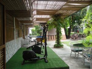 a room with a exercise bike on a green carpet at Lantana Pattaya - SHA Extra Plus in North Pattaya