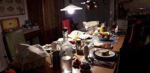 a table with food and a bottle on top of it at B&B kamers en meer Het Spookhuis in Den Hoorn