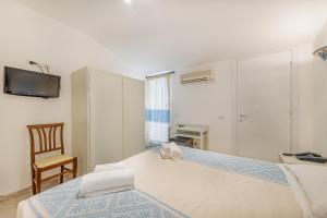 Postel nebo postele na pokoji v ubytování Hotel Le Mimose
