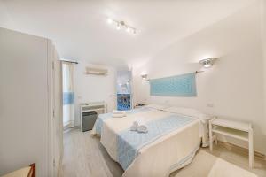 Postel nebo postele na pokoji v ubytování Hotel Le Mimose