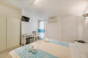 Postel nebo postele na pokoji v ubytování Hotel Le Mimose