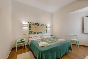 Postel nebo postele na pokoji v ubytování Hotel Le Mimose