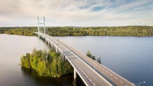 a bridge over a body of water with cars on it at 1-Bedroom Apartment with Sauna in Heinola