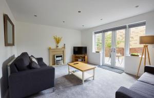 a living room with a couch and a table at Listers Lodge in Halifax