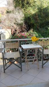 a picnic table and two chairs sitting on a patio at Villa Marina Apartments in Diano Marina