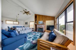 a living room with a blue couch and a fireplace at The Eagle's Nest in Lincoln City