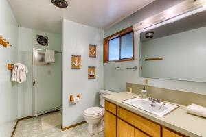a bathroom with a sink and a toilet and a mirror at Rustic Retreat on Mercer Lake in Florence