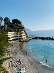 a group of people on a beach in the water at Casa Mia Bogliasco Mare & Centro in Bogliasco